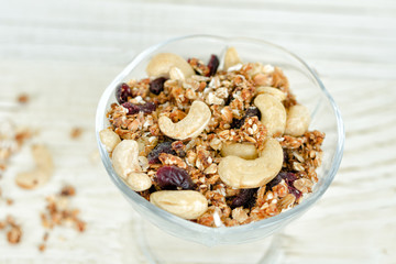 Pialat granola with nuts on a white table. Close-up