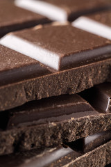 Bitter dark chocolate pieces on the heap, selective focus, macro image