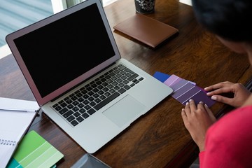 Fototapeta premium Cropped image of woman arranging color swatches