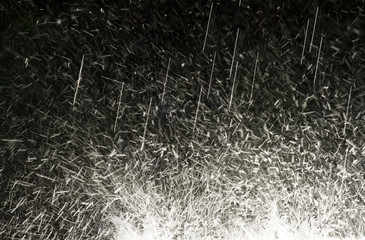 Sprinkling and splashing water against black background with copy space.