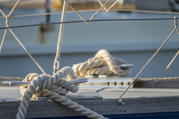 detail of sailor knot rope cleat on a sail boat at sea