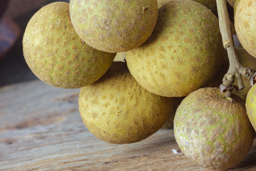 Longan Fresh on a wooden background.