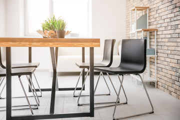 Modern room interior with wooden table
