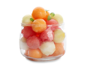 Jar with fresh melon and watermelon balls on white background