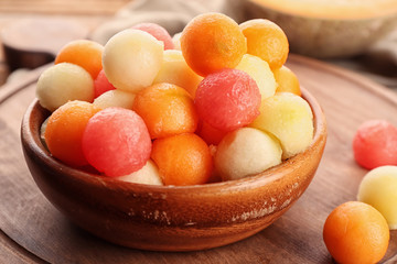 Plate with fresh melon and watermelon balls on table