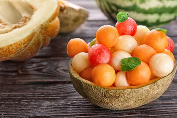 Plate with fresh melon and watermelon balls on table