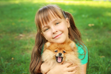 Cute girl with little dog, outdoors