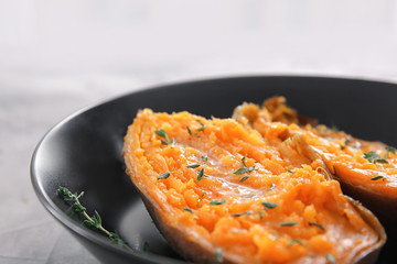 Plate with baked sweet potato, closeup