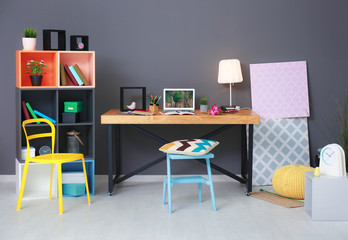 Modern room interior with laptop on table