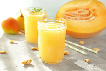 Jar of fresh melon smoothie on table