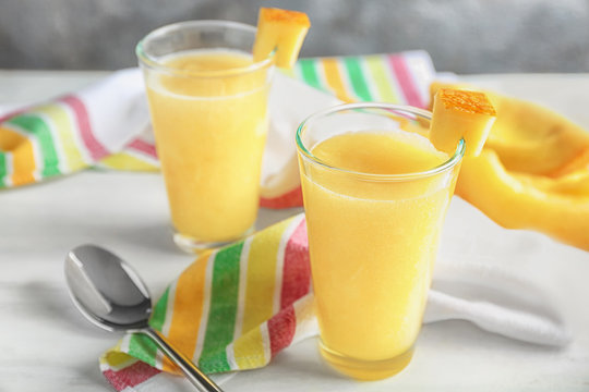 Glasses of fresh melon smoothie on table