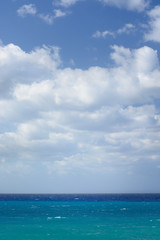 The cloudy sky and the sea with waves