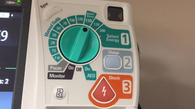 A close up of a defibrillator. It alarms to deliver the shock to a patient.