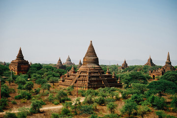 View across pagodas towards Thatbinnyu Temple Pagoda in Bagan My