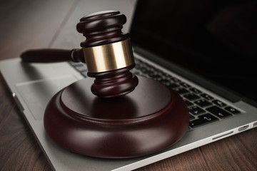 judge gavel on a laptop cyber crime concept