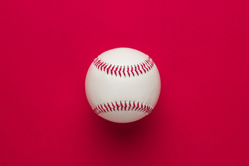 top view of baseball ball on red background