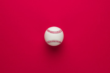 top view of baseball ball on red background