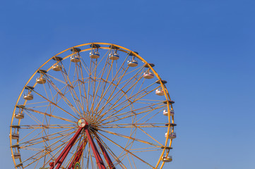 Big adventure speed circle high rollercoaster in the park with clean blue sky