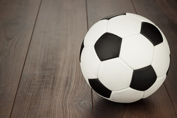 Fototapeta na wymiar soccer ball on the brown wooden table