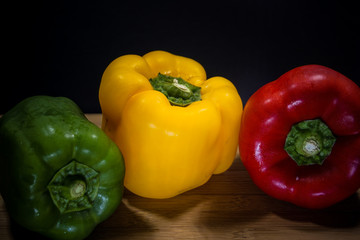 Colorful capsicum on wooden table background.Image with selective focus.