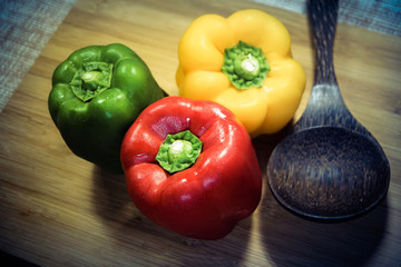 Colorful capsicum on wooden table background.Image with selective focus.