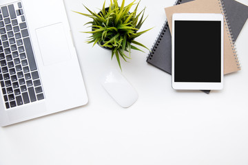 office desk table work space top overhead place layout left laptop keyboard center plant with mouse for use right laptop isolated on notebook