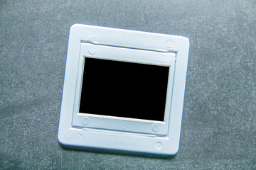 Plastic film slide on chalkboard background