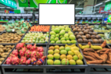 Blank supermarket TV screen and blurred supermarket fruits background