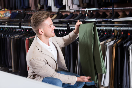 Ordinary Man Choosing New Trousers