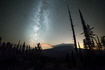 Milky way over a shrouded Mt. Hood and night sky with stars