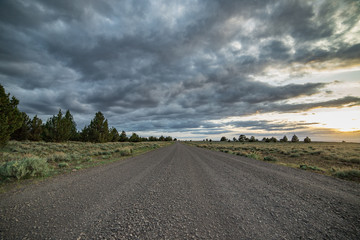 Dramatic empty gravel road into the unknown