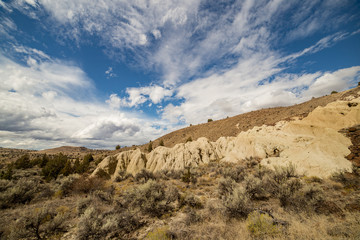 Fototapeta na wymiar Badlands formations in the High Desert and blue skies