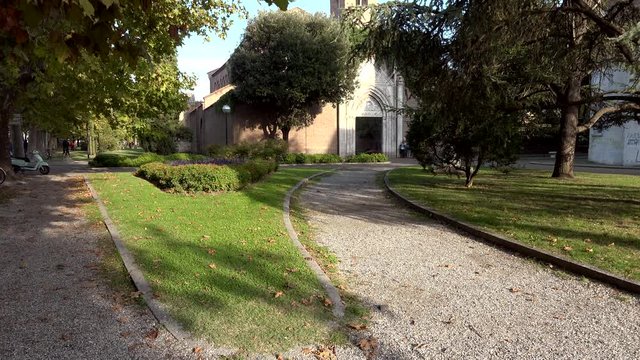panning shot of garden path to Medieval Catholic Church in Ravenna, Italy