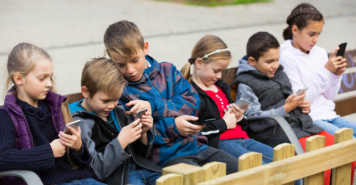 Children with mobile devices communicate