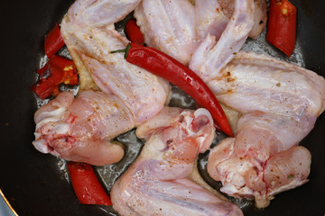 raw chicken wings with red pepper