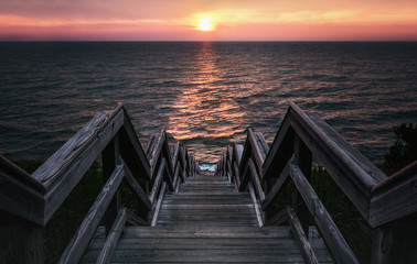 Surreal Sunset Stairway to the Sea. Low Key Vintage Style with Copy Space.