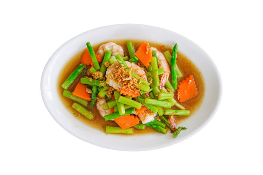 stir fried asparagus and carrot with shrimp on white plate isolated on white background with clipping path
