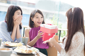 happy woman friends in restaurant