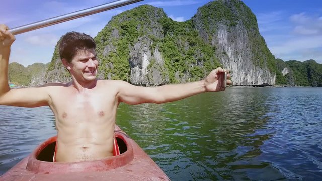 Joyful Man Makes Faces Does Selfie Shakes Paddle in Kayak