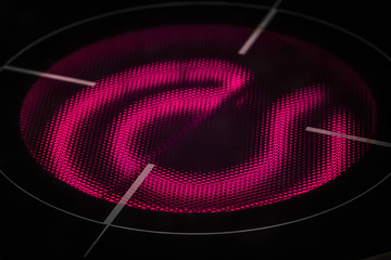 The red-hot red-burner induction hob close up.