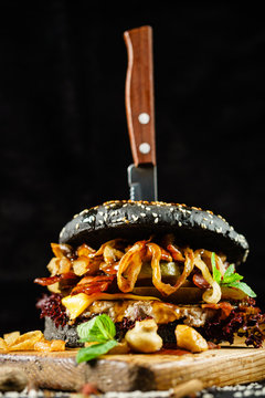 creative black burger with beef and bacon
