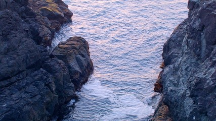 Waves lap between rocks at sunset from cliff Oregon Coast Oregon 20
