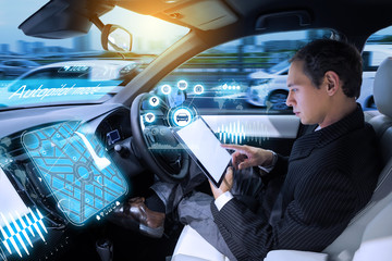 Caucasian man riding autonomous car. Self driving vehicle. Driverless car. 