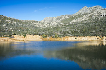 Views of La Maliciosa Reservoir, in Guadarrama Mountains (Madrid, Spain), with La Maliciosa peak in the background.