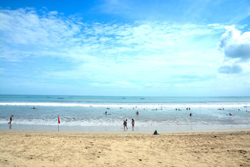 Fototapeta na wymiar Kuta Beach in Bali, Indonesia. Famous beach with blue skies and white sands.