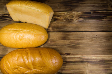 Assortment of baked bread on wooden table