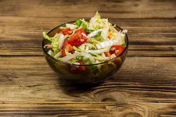 Fresh vegetable salad on wooden table
