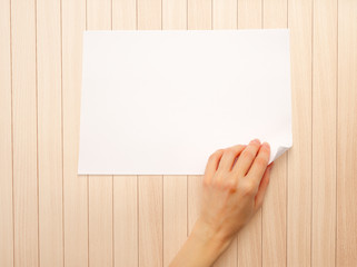 Woman's hand turning over paper