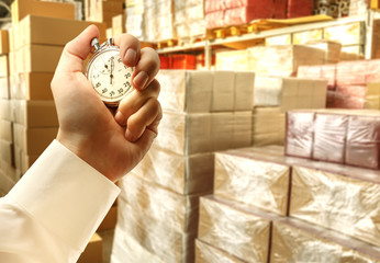 Paper products storehouse and stopwatch in hand