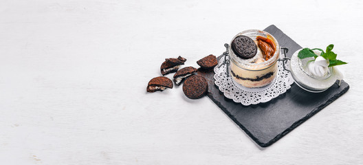 Tiramisu Dessert of cookies and mascarpone cheese. On a wooden surface. Top view. Free space for your text.